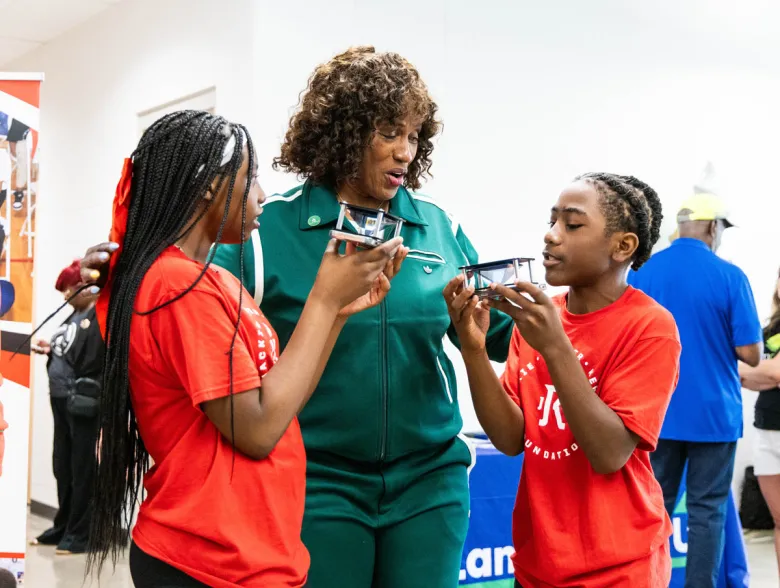 Vinecia Farley and Amon Frazier explain 3D models to Jackie Joyner-Kersee during the grand opening of the Jackie Joyner-Kersee Food, Agriculture, Nutrition Innovation Center. Photo by Lawrence Bryant | St. Louis American